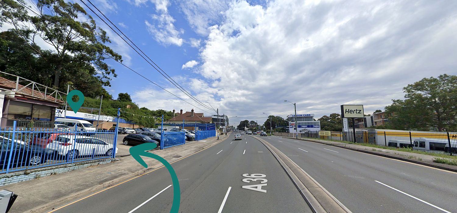 View south down the Princes Highway, Arncliffe: Convertible & Sunroof Autocentre is on the left, opposite the Hertz sign